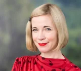Lucy Worsley wearing a red patterned dress at Hay Festival in 2019