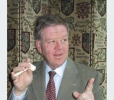 Archive portrait of auctioneer Philip Serrell holding an auction gavel