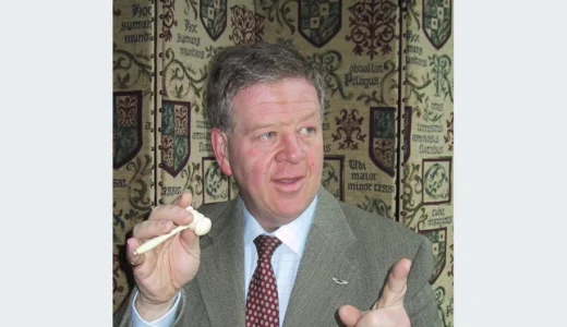 Archive portrait of auctioneer Philip Serrell holding an auction gavel