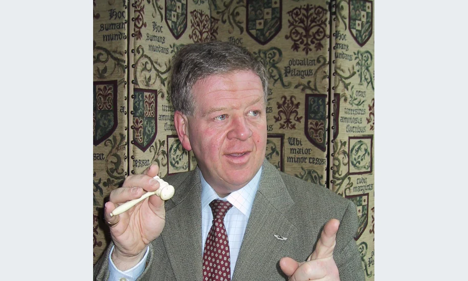 Archive portrait of auctioneer Philip Serrell holding an auction gavel
